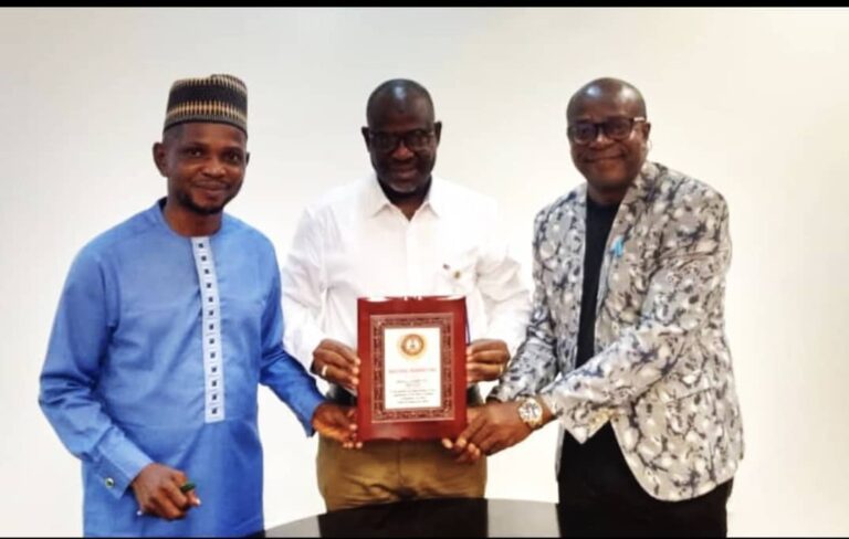 Plant Director, Mohammed Ismaeel, Dangote Okpella Cement Limited, holding the Integrated Management System (IMS) Certificate, with other members of staff